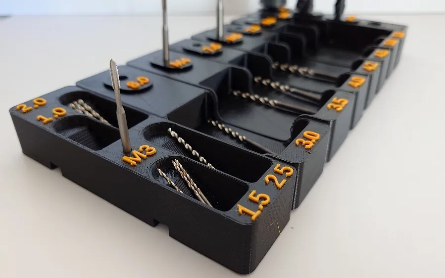 Custom black organizer holding drill bits with orange size markings